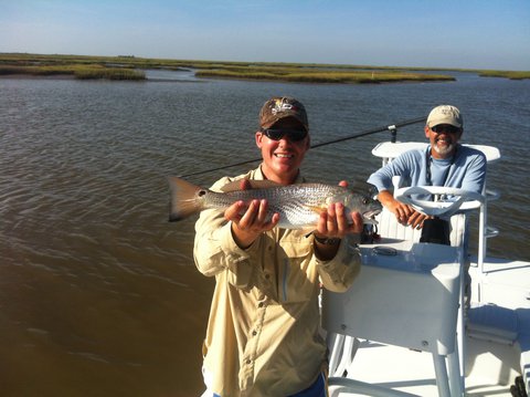 Here is my buddy Chris with his first ever redfish on his first trip in the marsh (he is surely forever ruined after this trip)